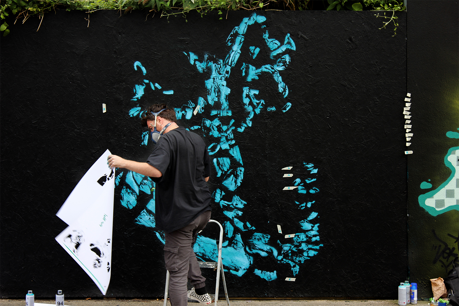 D!VE painting a stencil at Waterford Walls festival